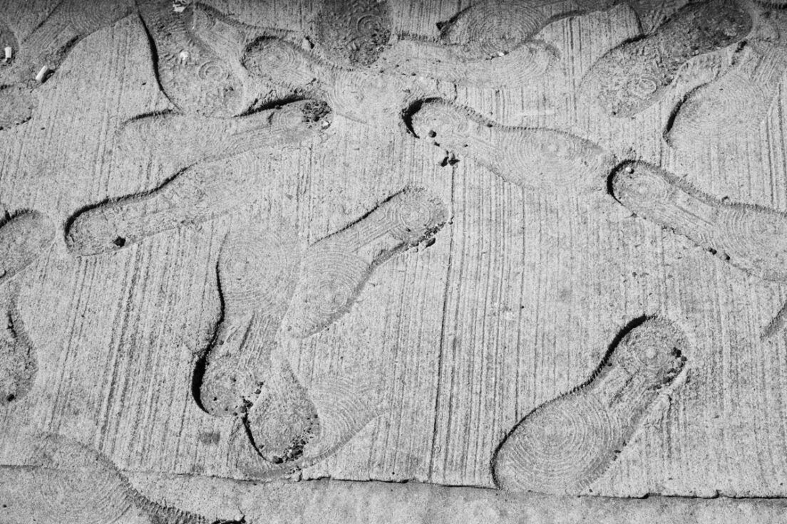 Sneaker prints in the concrete on Canal Street in Tribeca
