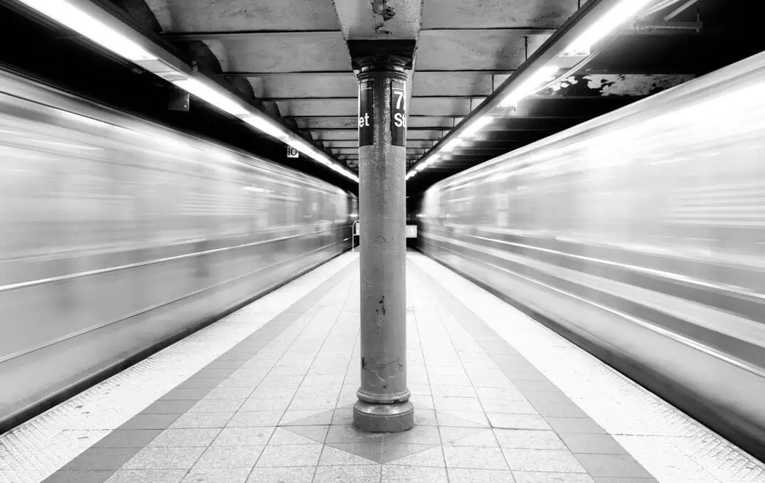 Two subway trains in motion on the 72nd Street line.