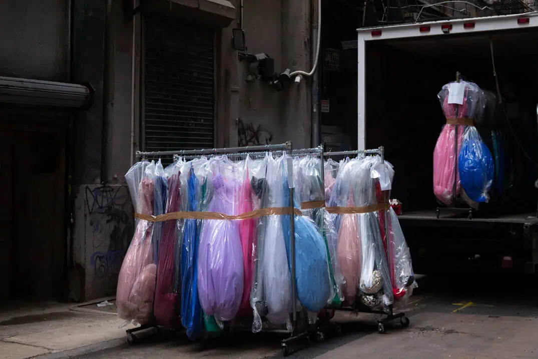Dresses hanging outside a garment shop in Cortlandt Alley, Lower East Side, New York
