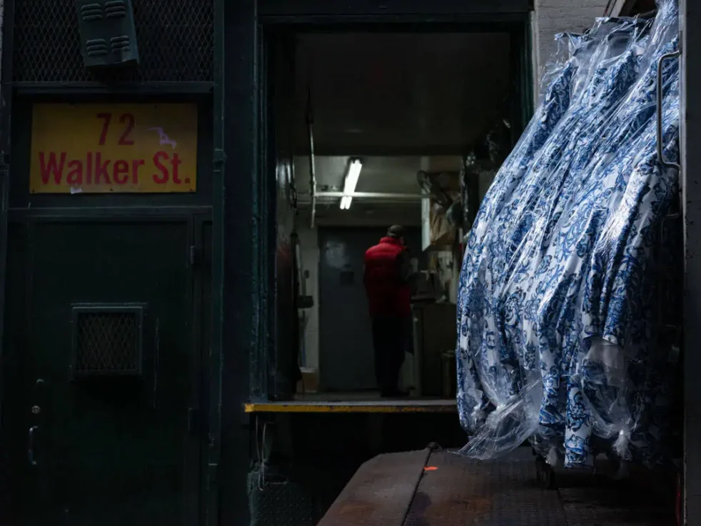 Dresses outside a sweatshop with a man on Cortlandt Alley in Tribeca